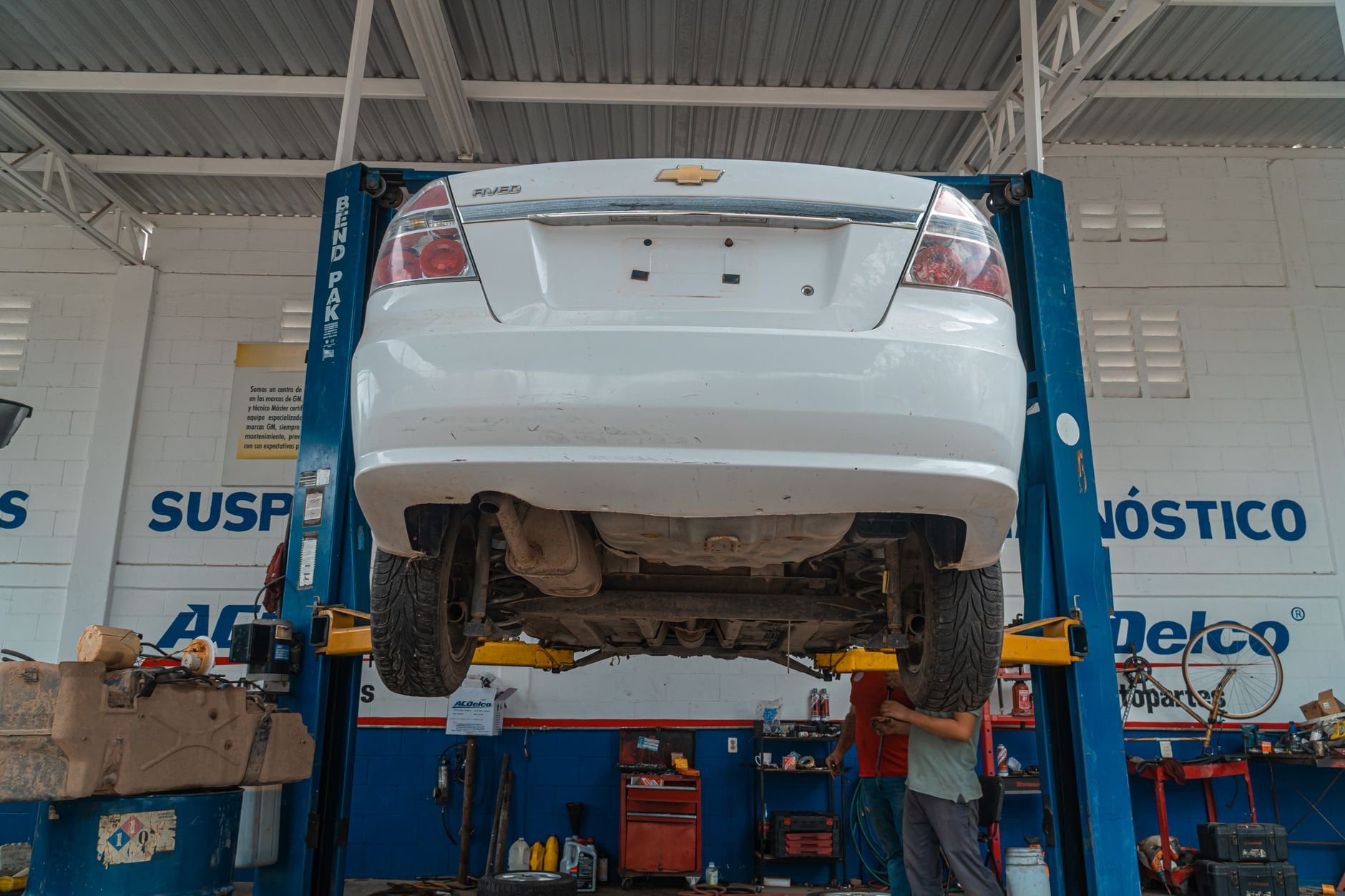 Professional two-post auto lift in an automotive repair shop